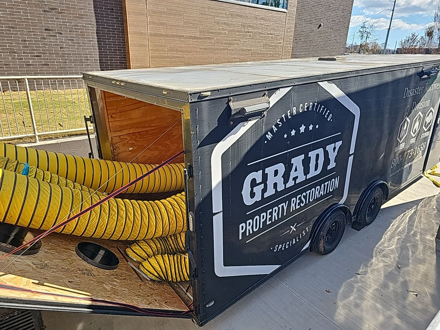 Grady Property Restoration large loss drying trailer supplying high-capacity ducted airflow for a commercial restoration project.